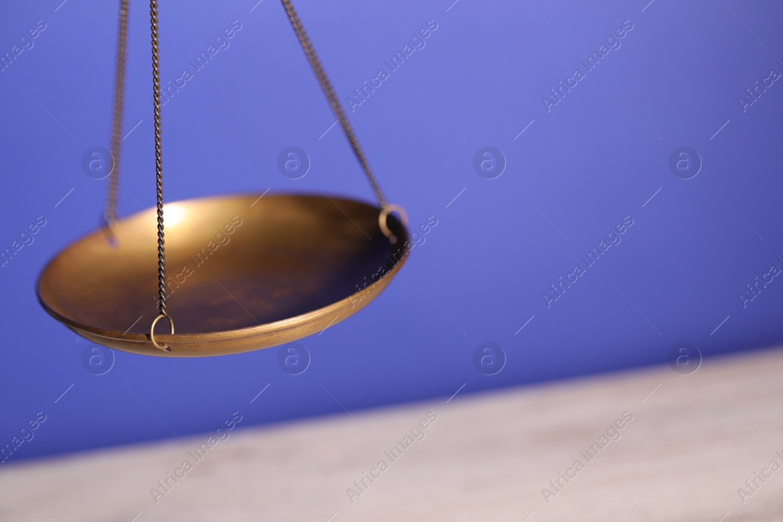 Photo of Scales of justice on color background, closeup