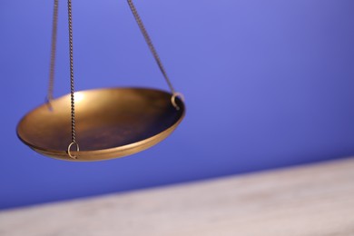 Photo of Scales of justice on color background, closeup