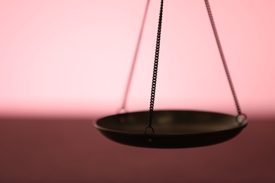 Photo of Scales of justice on color background, closeup