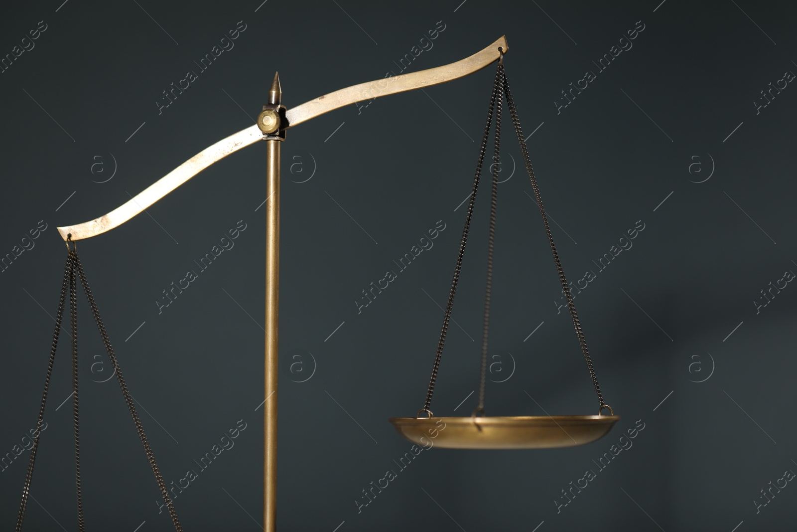 Photo of Scales of justice on gray background, closeup