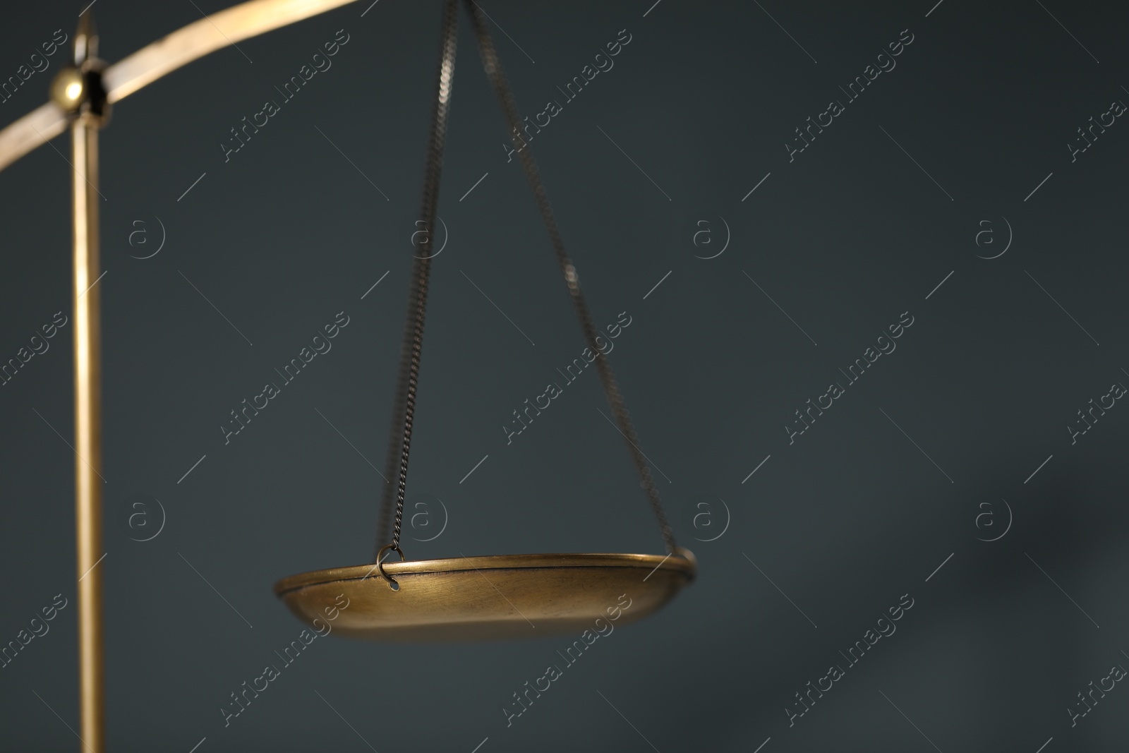Scales of justice on gray background, closeup. Space for text Photo of Scales of justice on gray background, closeup. Space for text