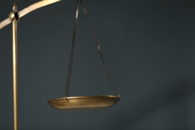 Photo of Scales of justice on gray background, closeup. Space for text