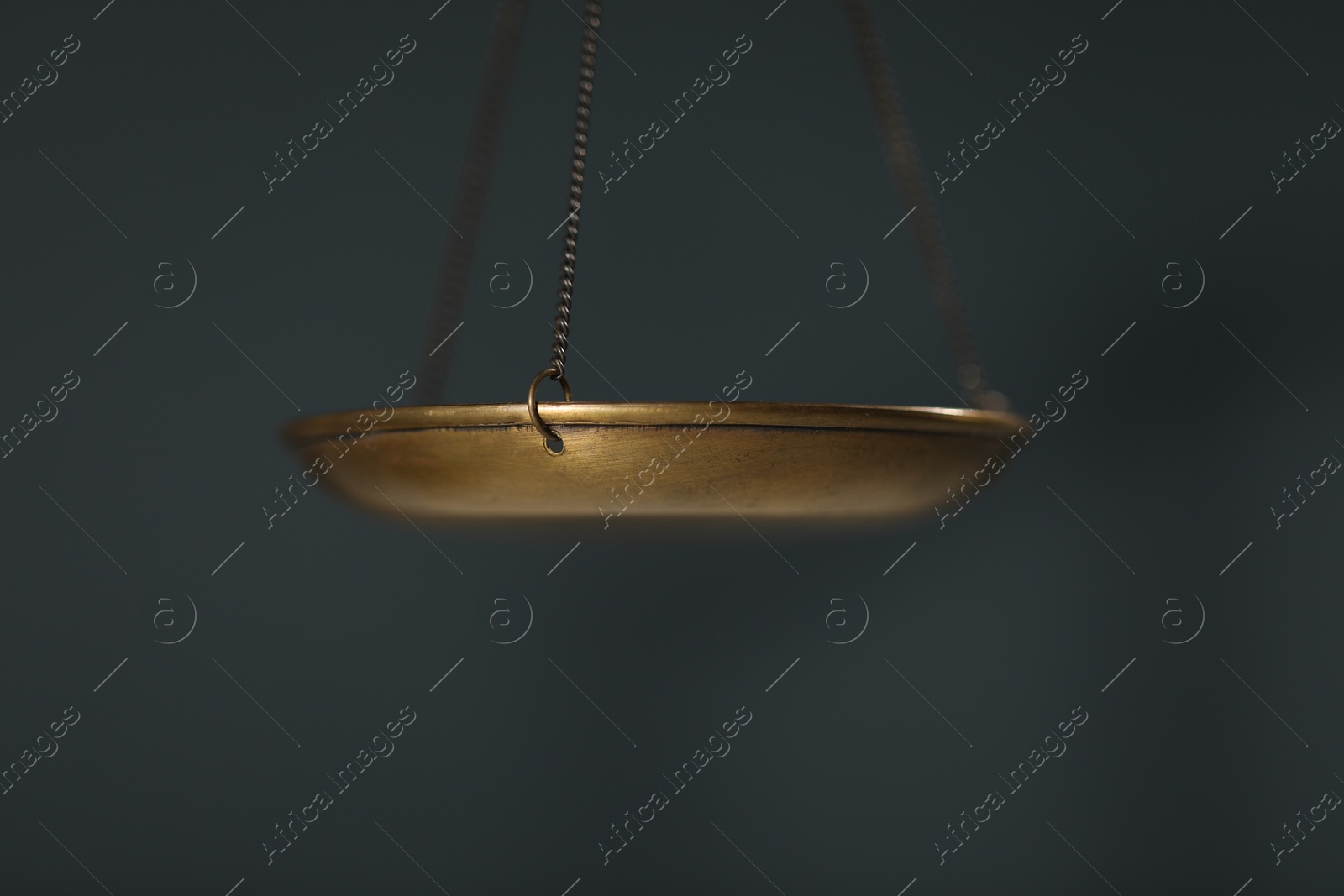 Photo of Scales of justice on gray background, closeup