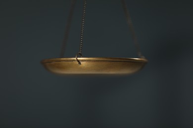 Photo of Scales of justice on gray background, closeup