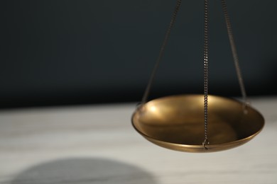 Photo of Scales of justice on color background, closeup. Space for text