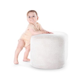 Photo of First steps. Cute little baby in diaper near pouf on white background