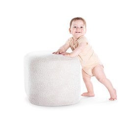Photo of First steps. Cute little baby in diaper near pouf on white background