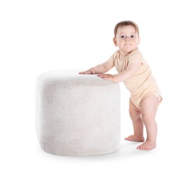 Photo of First steps. Cute little baby in diaper near pouf on white background