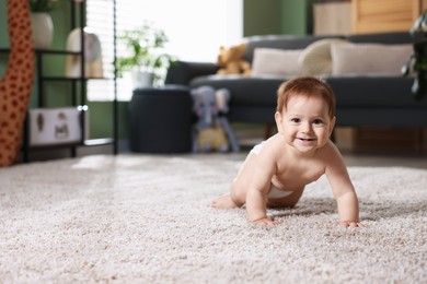 Photo of Cute little baby crawling on carpet at home, space for text