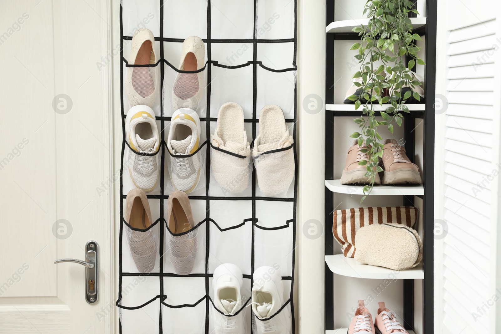Organizer with different footwear and accessories indoors. Shoe storage Photo of Organizer with different footwear and accessories indoors. Shoe storage