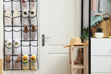 Photo of Organizer with different footwear and accessories indoors. Shoe storage