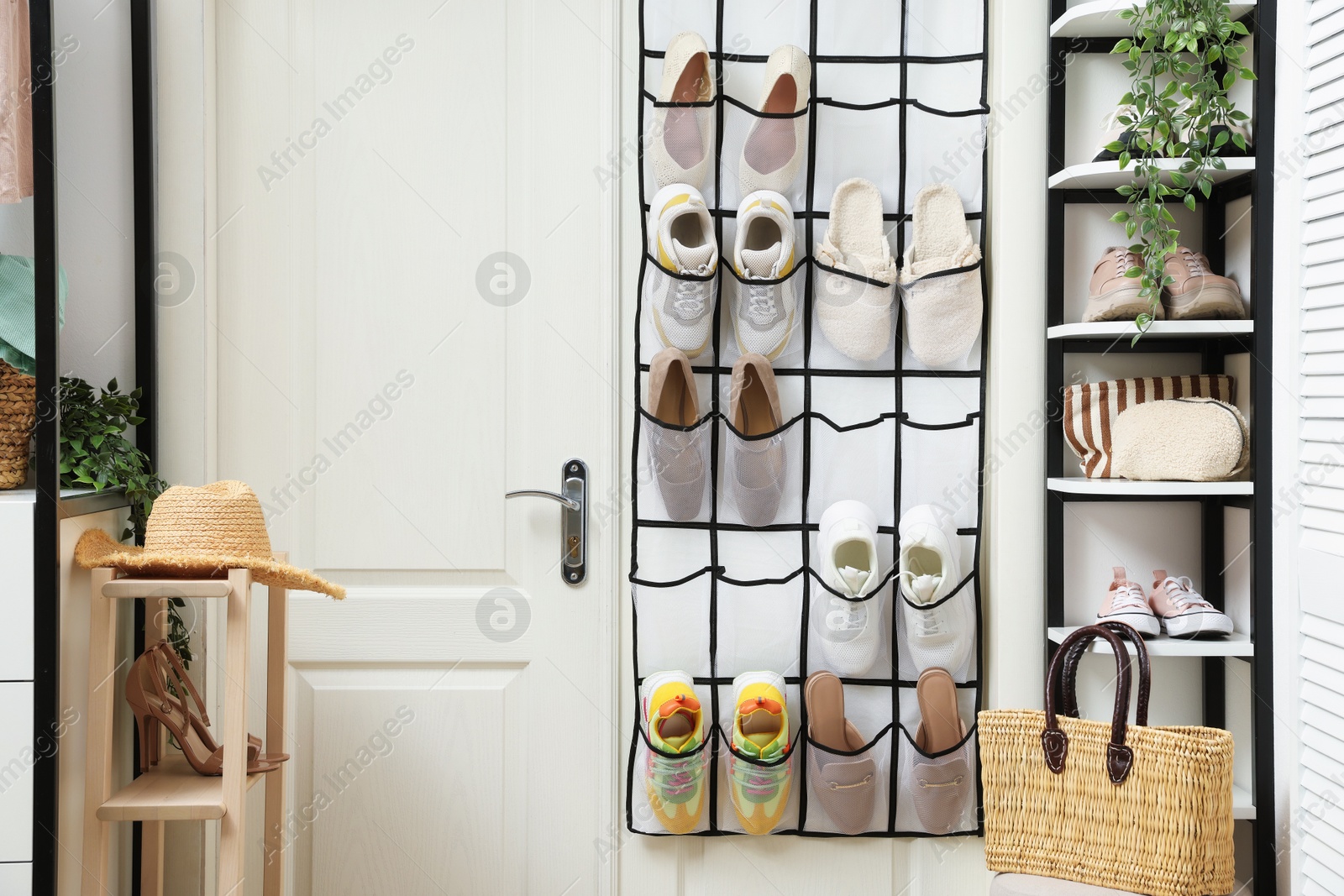 Organizer with different footwear and accessories indoors. Shoe storage Photo of Organizer with different footwear and accessories indoors. Shoe storage