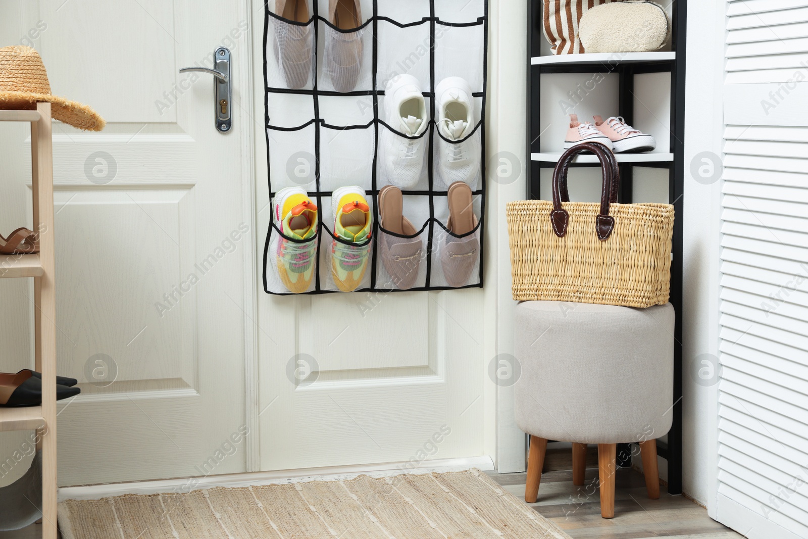 Organizer with different footwear and accessories indoors. Shoe storage Photo of Organizer with different footwear and accessories indoors. Shoe storage