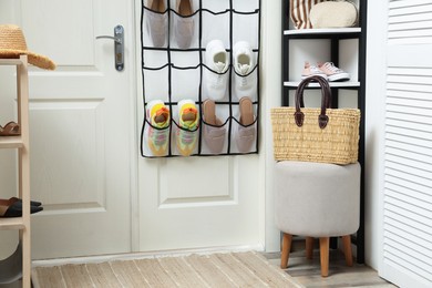 Photo of Organizer with different footwear and accessories indoors. Shoe storage