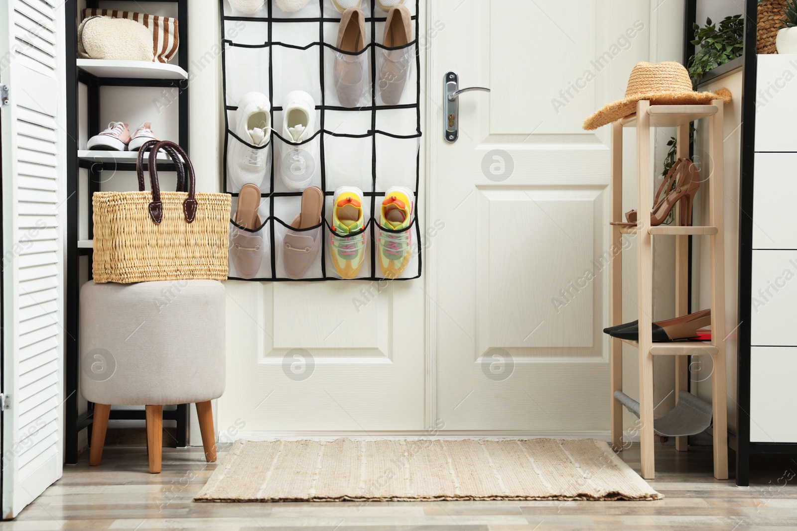 Organizer with different footwear and accessories indoors. Shoe storage Photo of Organizer with different footwear and accessories indoors. Shoe storage