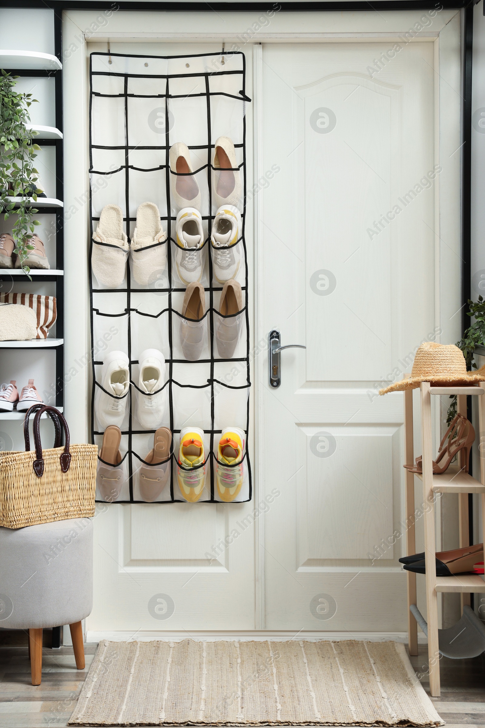 Organizer with different footwear and accessories indoors. Shoe storage Photo of Organizer with different footwear and accessories indoors. Shoe storage