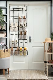 Photo of Organizer with different footwear and accessories indoors. Shoe storage