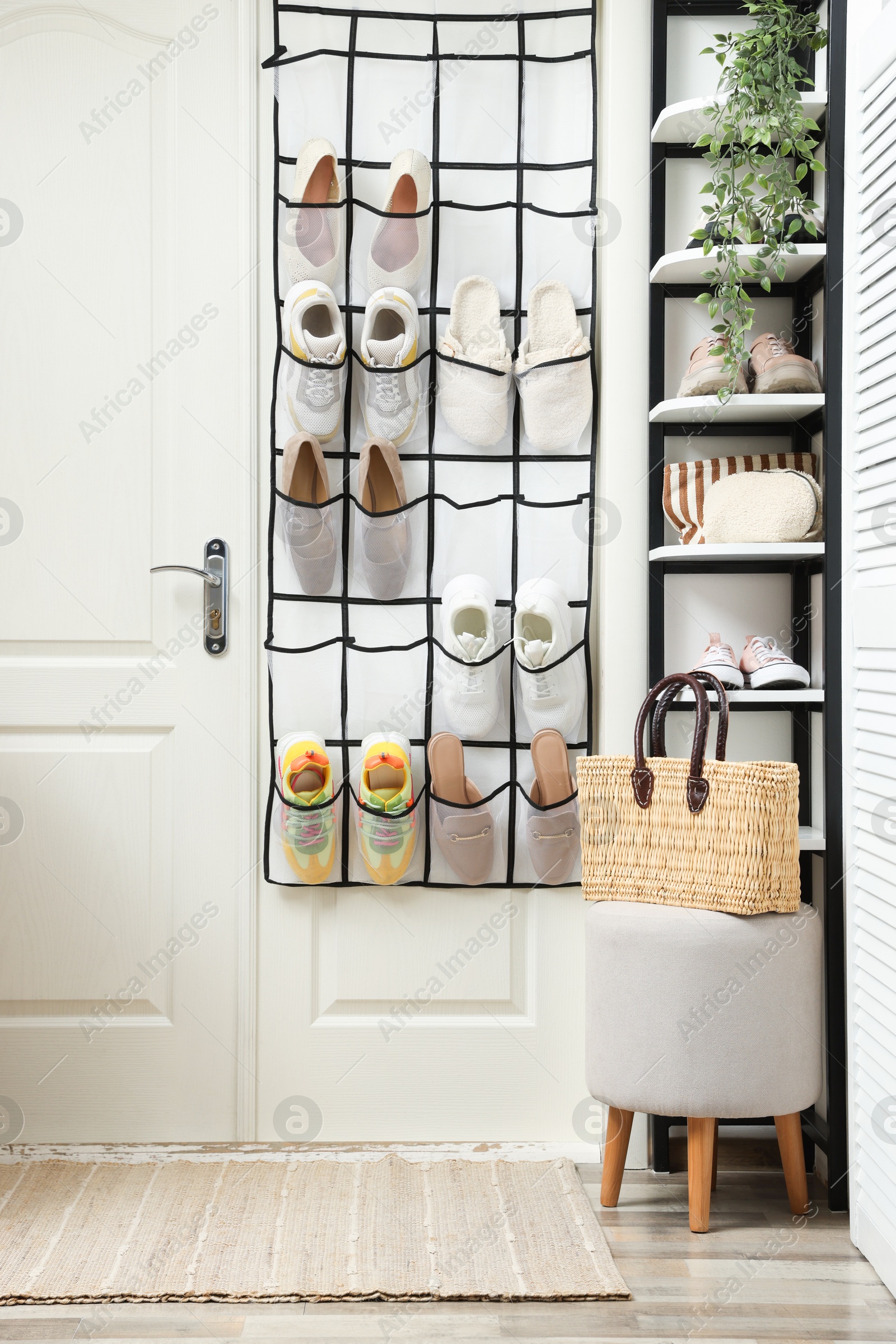 Organizer with different footwear and accessories indoors. Shoe storage Photo of Organizer with different footwear and accessories indoors. Shoe storage