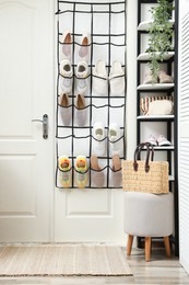 Photo of Organizer with different footwear and accessories indoors. Shoe storage