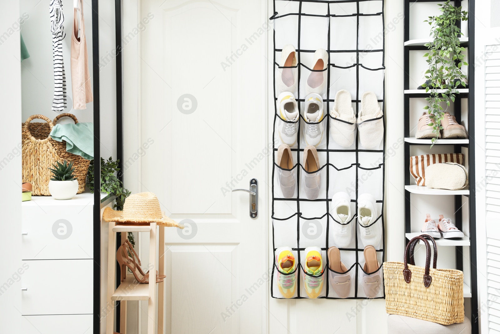 Organizer with different footwear and accessories indoors. Shoe storage Photo of Organizer with different footwear and accessories indoors. Shoe storage