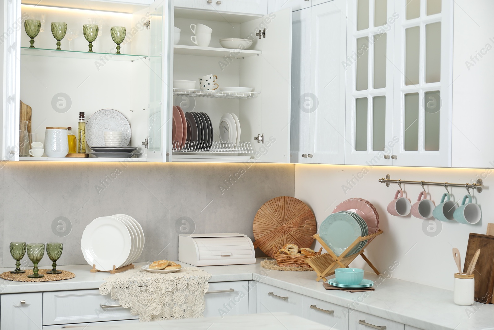 Photo of Different dishware, glasses and other kitchen utensils indoors