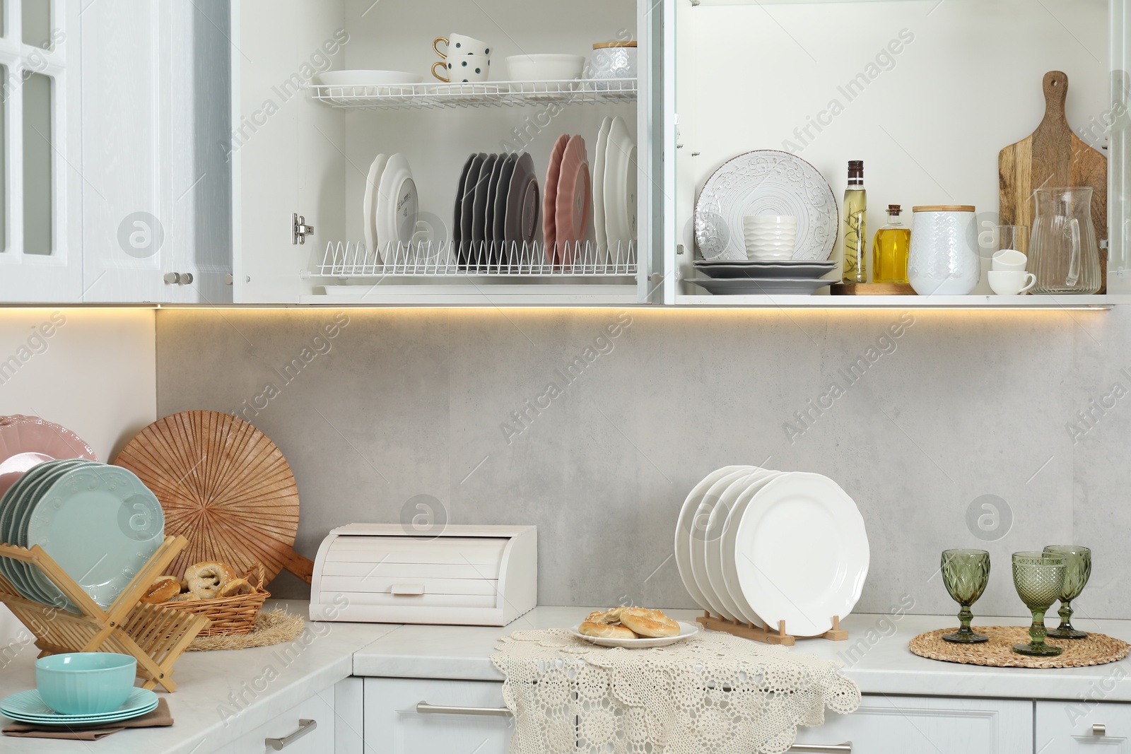 Photo of Different dishware, glasses and other kitchen utensils indoors