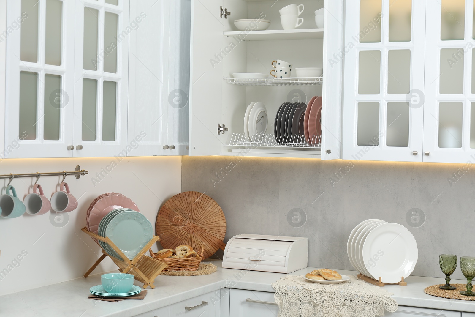 Photo of Different dishware, glasses and other kitchen utensils indoors