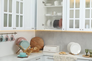 Photo of Different dishware, glasses and other kitchen utensils indoors
