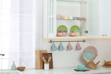 Photo of Different dishware, glasses and other kitchen utensils indoors