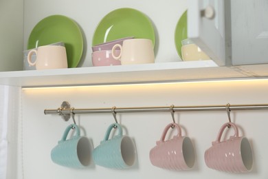 Photo of Different clean dishware and cups in kitchen