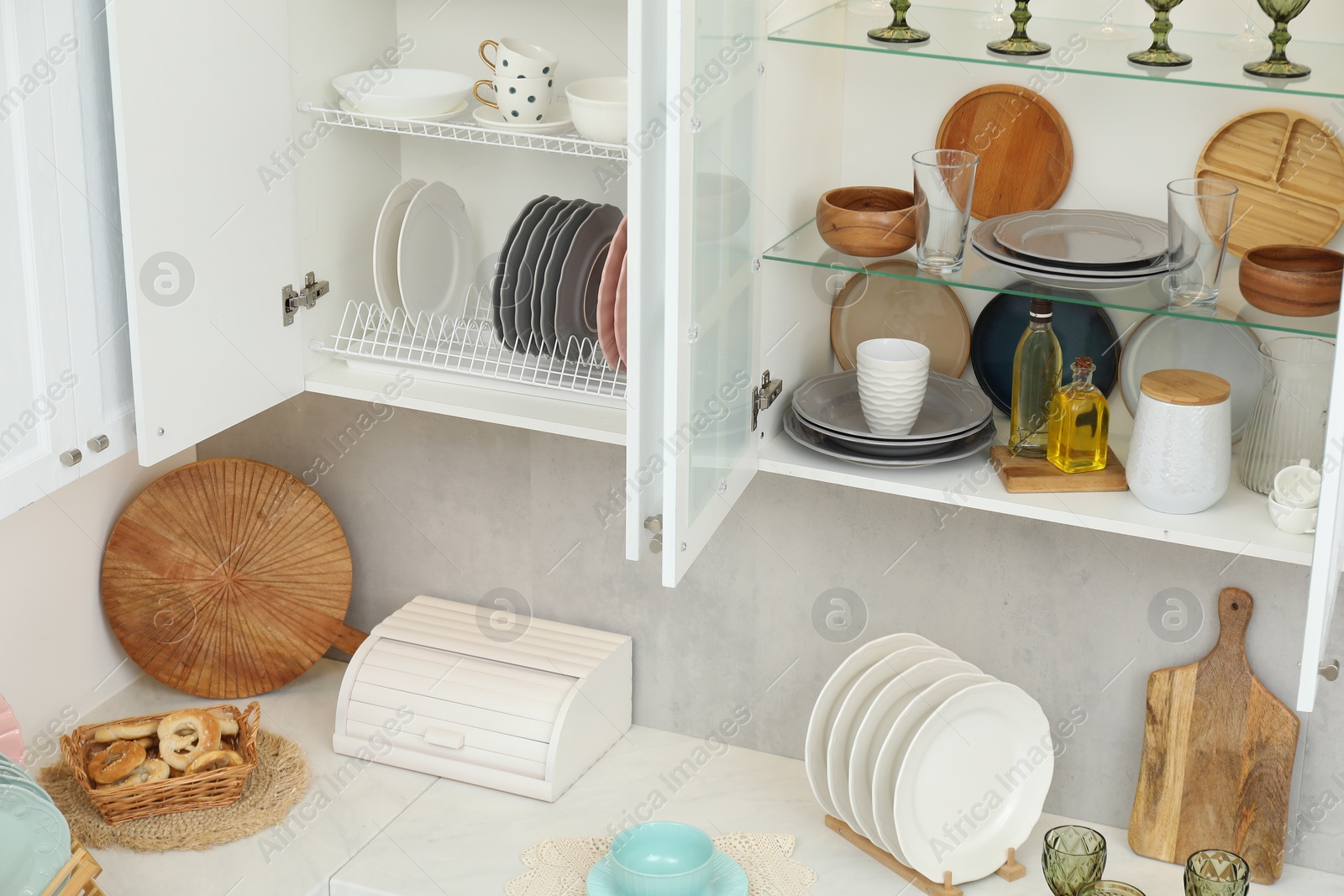 Photo of Different dishware, glasses and kitchen utensils indoors