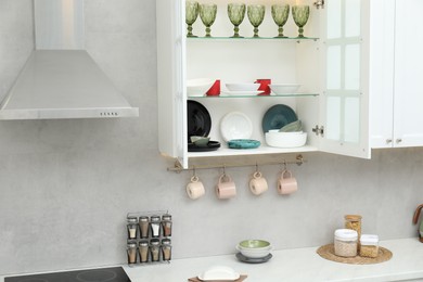 Photo of Different dishware, glasses and other kitchen utensils indoors