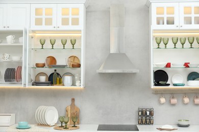 Photo of Different dishware, glasses and other kitchen utensils indoors