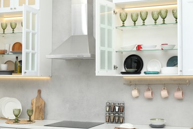 Photo of Different dishware, glasses and other kitchen utensils indoors