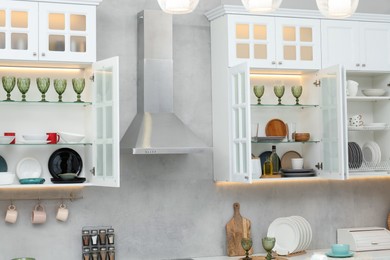 Photo of Different dishware, glasses and other kitchen utensils indoors