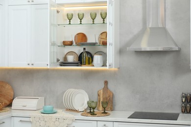 Photo of Different dishware, glasses and other kitchen utensils indoors