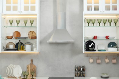 Photo of Different dishware, glasses and other kitchen utensils indoors