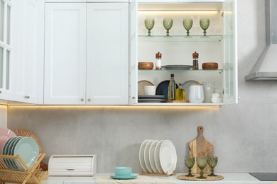Photo of Different dishware, glasses and other kitchen utensils indoors