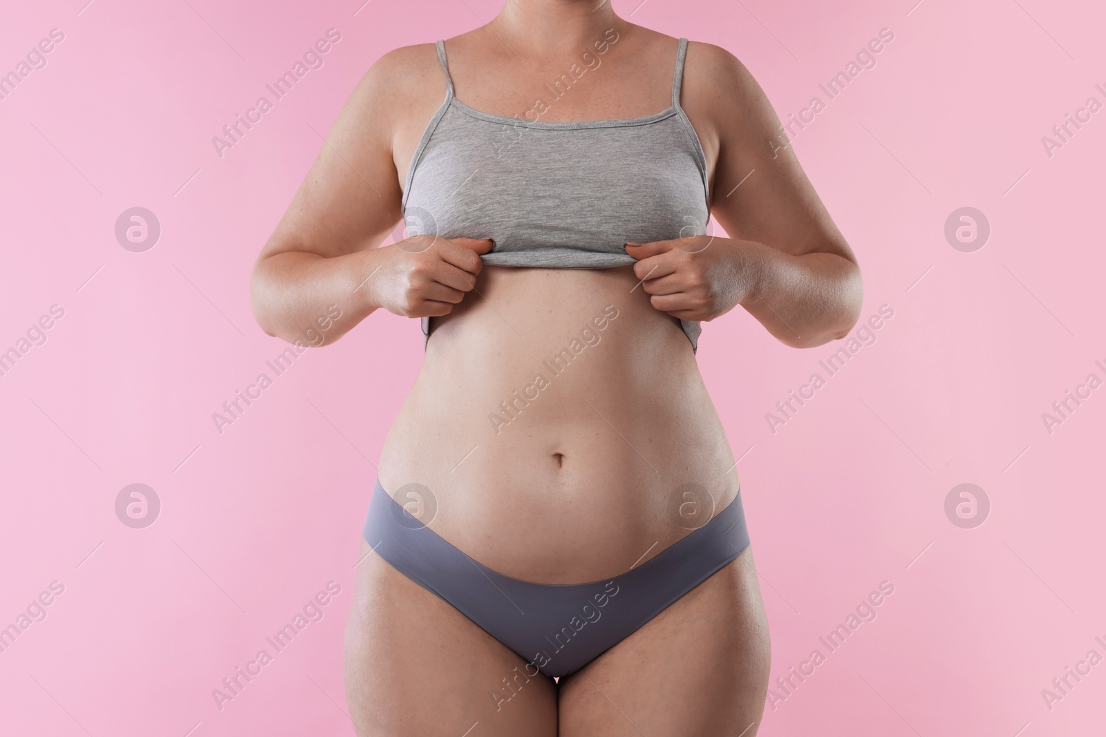 Photo of Liposuction. Woman in underwear on pink background, closeup