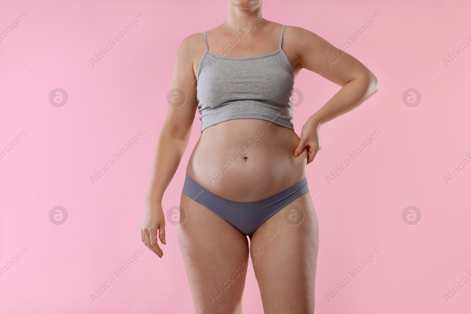 Photo of Liposuction. Woman in underwear on pink background, closeup
