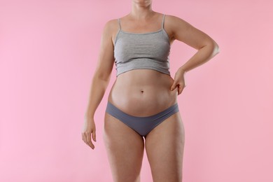 Photo of Liposuction. Woman in underwear on pink background, closeup