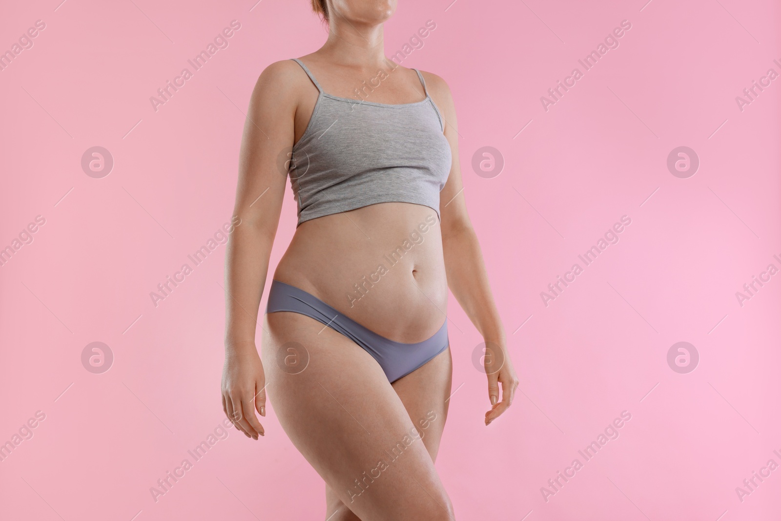 Photo of Liposuction. Woman in underwear on pink background, closeup