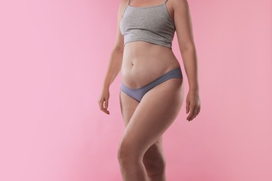 Photo of Liposuction. Woman in underwear on pink background, closeup