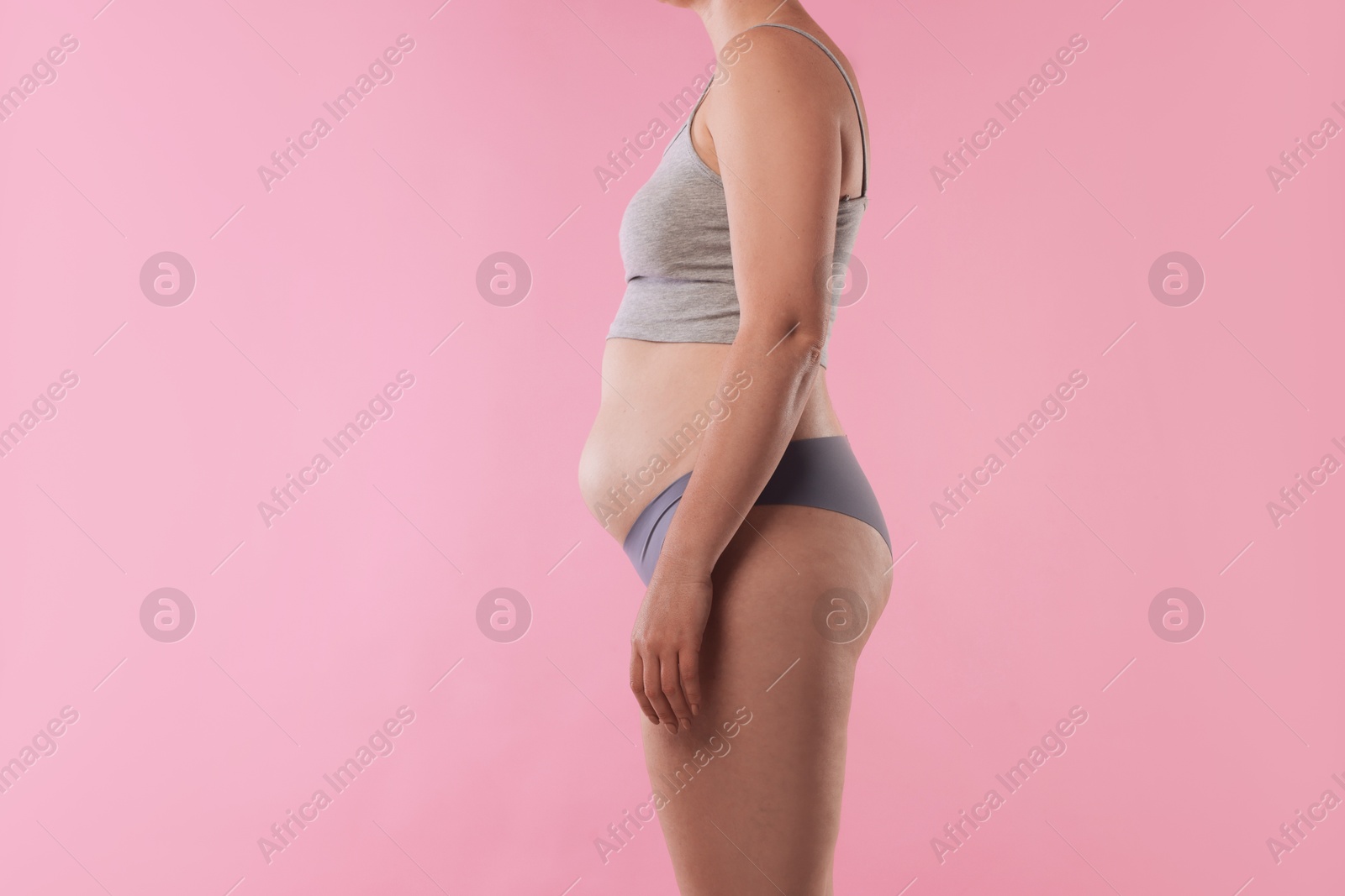 Liposuction. Woman in underwear on pink background, closeup Photo of Liposuction. Woman in underwear on pink background, closeup