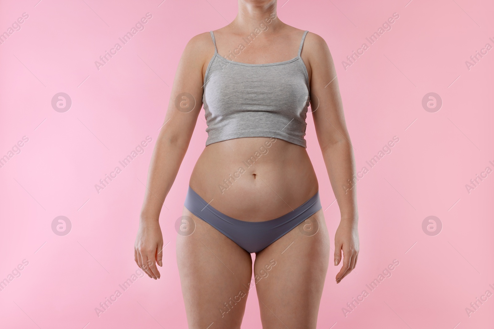 Photo of Liposuction. Woman in underwear on pink background, closeup