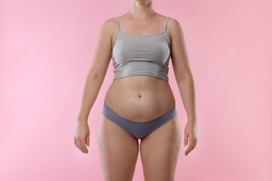 Photo of Liposuction. Woman in underwear on pink background, closeup