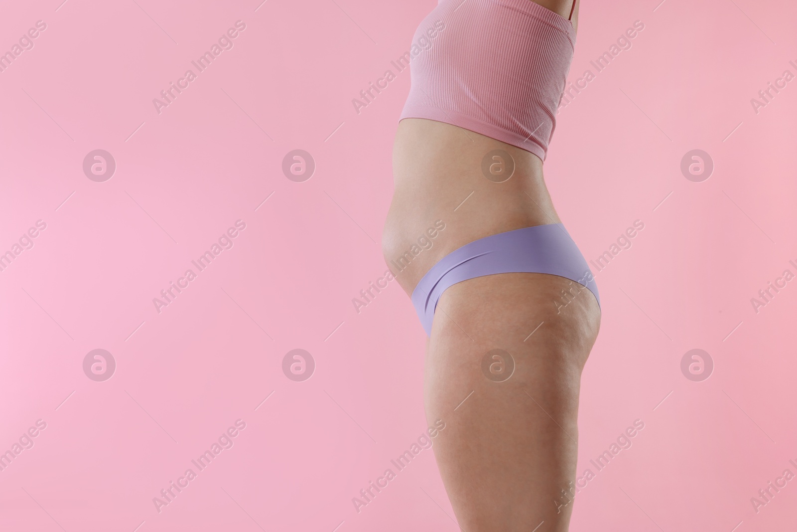 Liposuction. Woman in underwear on pink background, closeup. Space for text Photo of Liposuction. Woman in underwear on pink background, closeup. Space for text