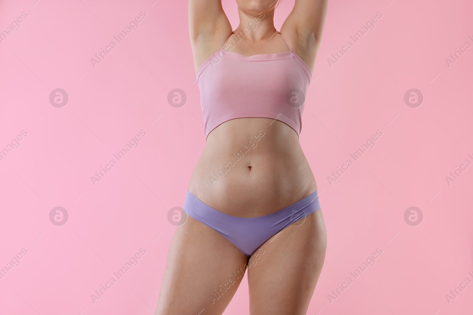 Photo of Liposuction. Woman in underwear on pink background, closeup