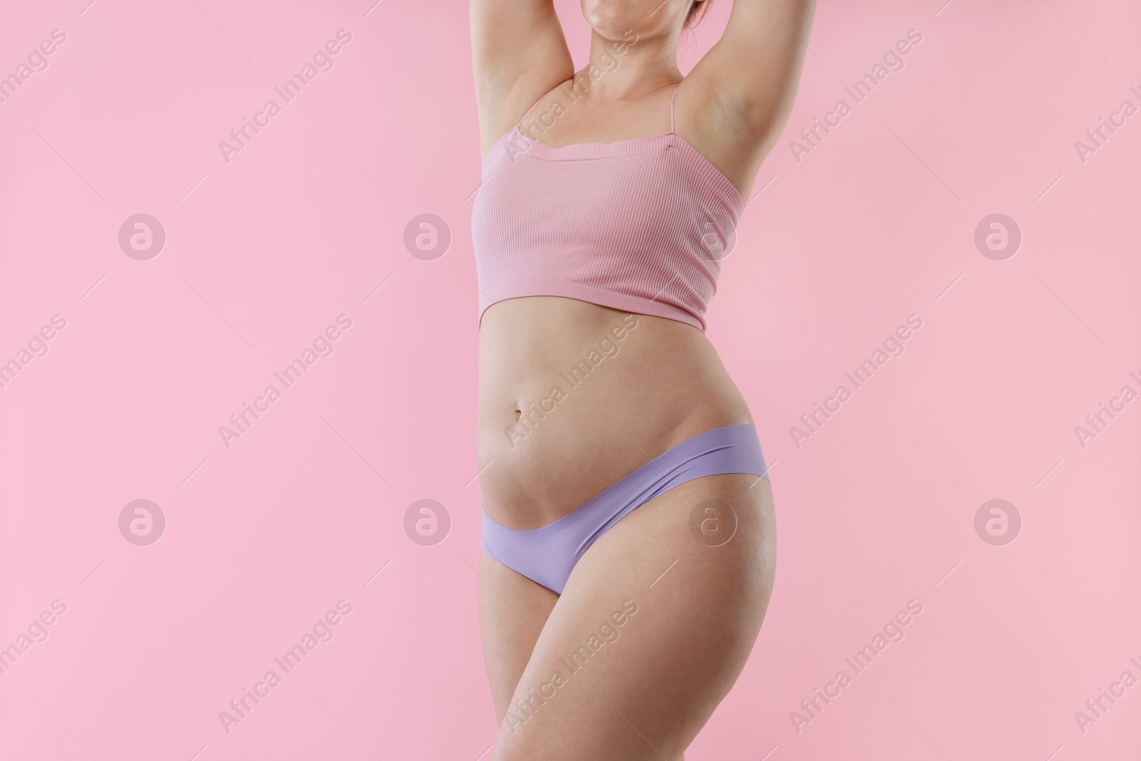 Photo of Liposuction. Woman in underwear on pink background, closeup