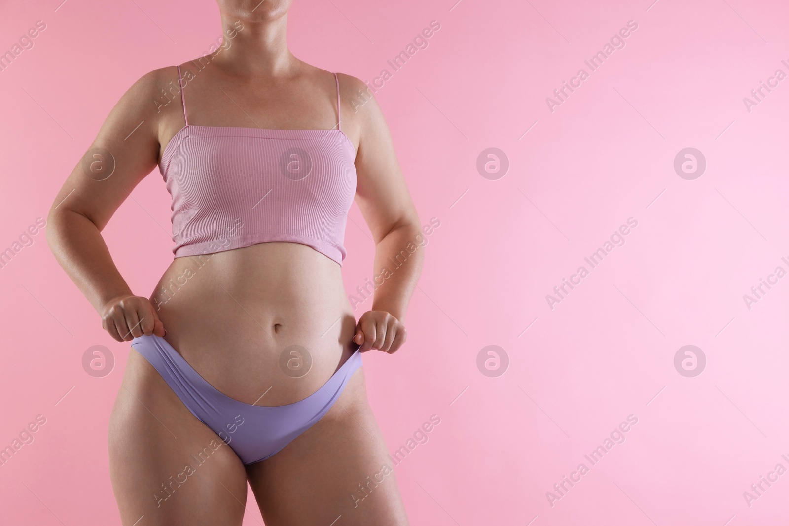 Liposuction. Woman in underwear on pink background, closeup. Space for text Photo of Liposuction. Woman in underwear on pink background, closeup. Space for text